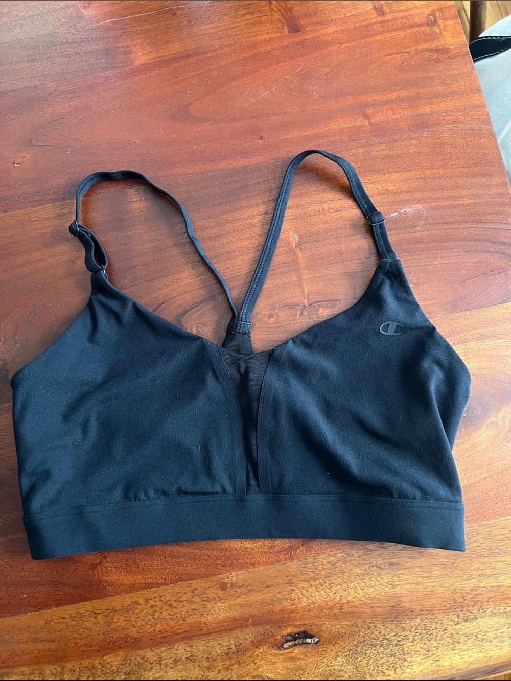 Black champion sports bra with sheer panel in the front.